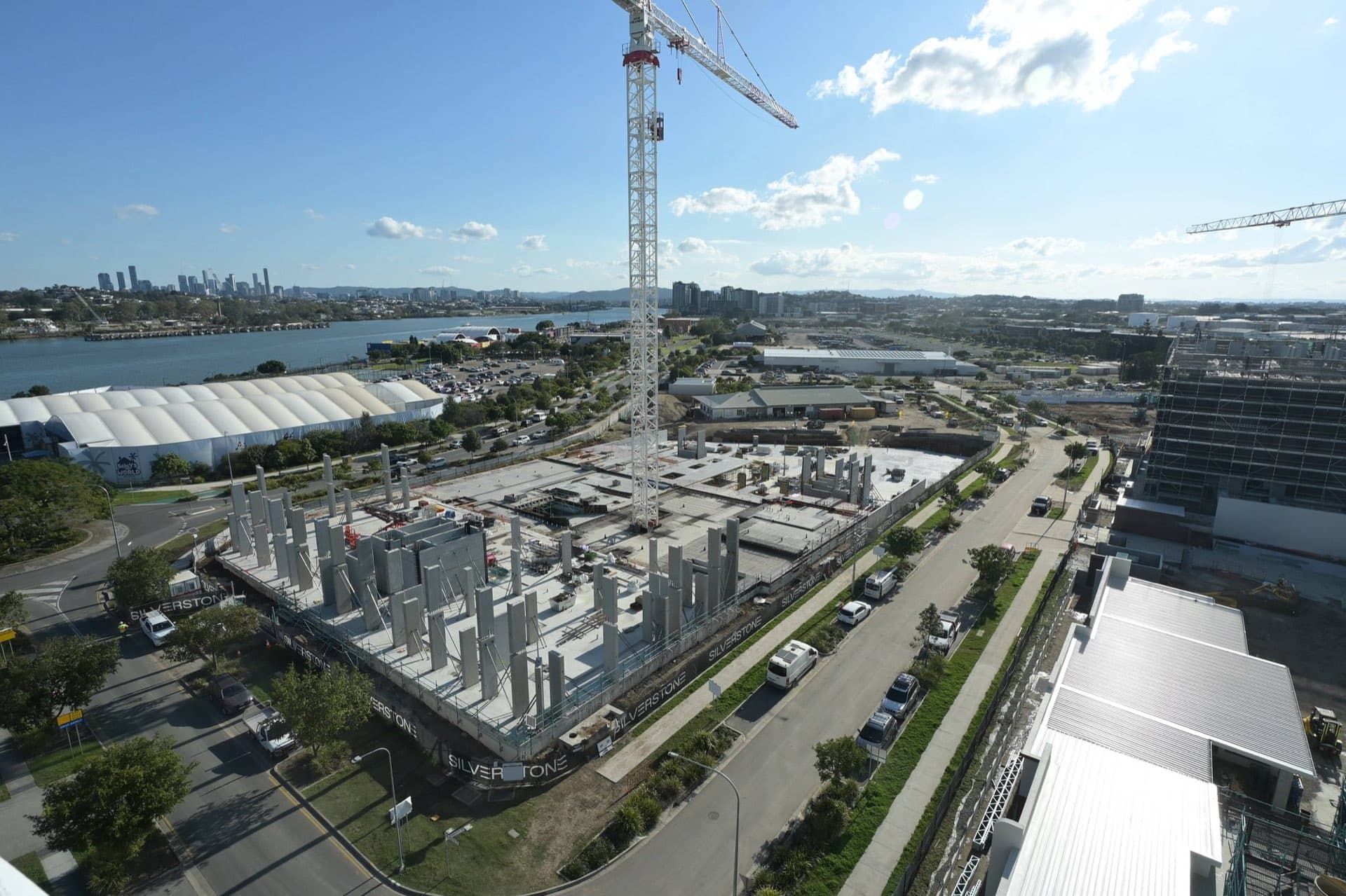 Aerial view of the Rivergreen construction site with Brisbane city skyline in the background